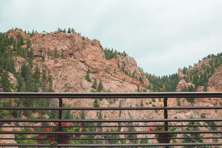 A Fence In Front Of A Rocky Mountain