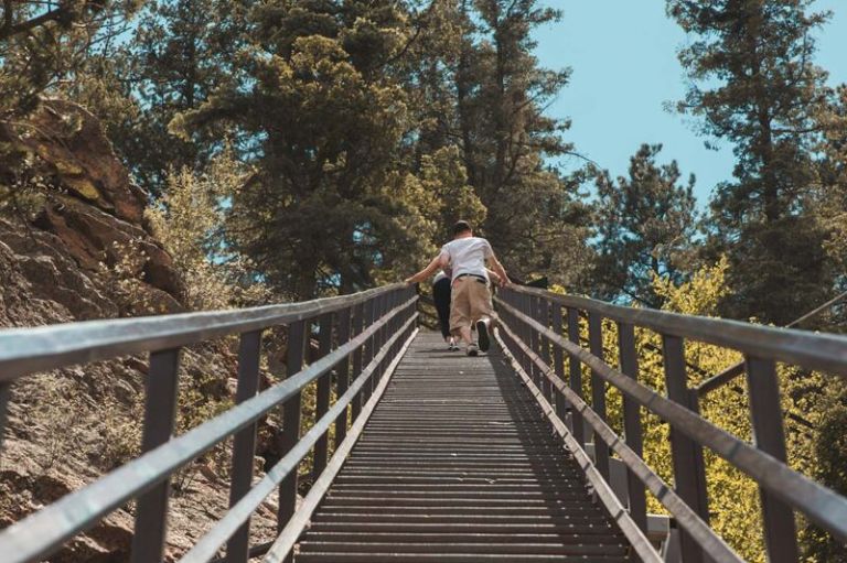 A Person Riding A Wooden Bridge