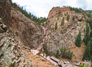 A Road Going Through A Rocky Mountain