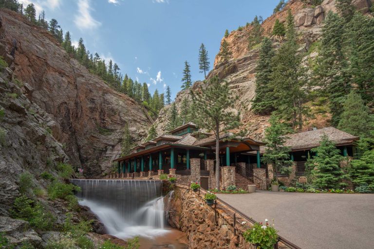 A House On A Cliff By A Waterfall