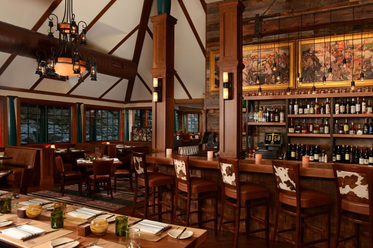 A Large Bar With Tables And Chairs