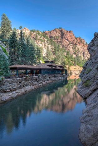 A Building On A Cliff By A Lake
